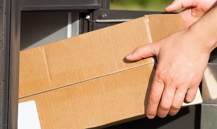 Person pulling package out of mailbox