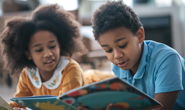 A boy and a girl looking at a book together