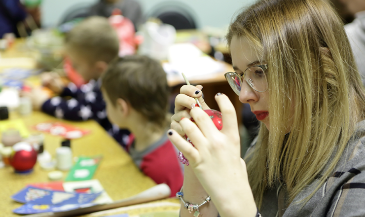 Teen girl painting during a children craft event